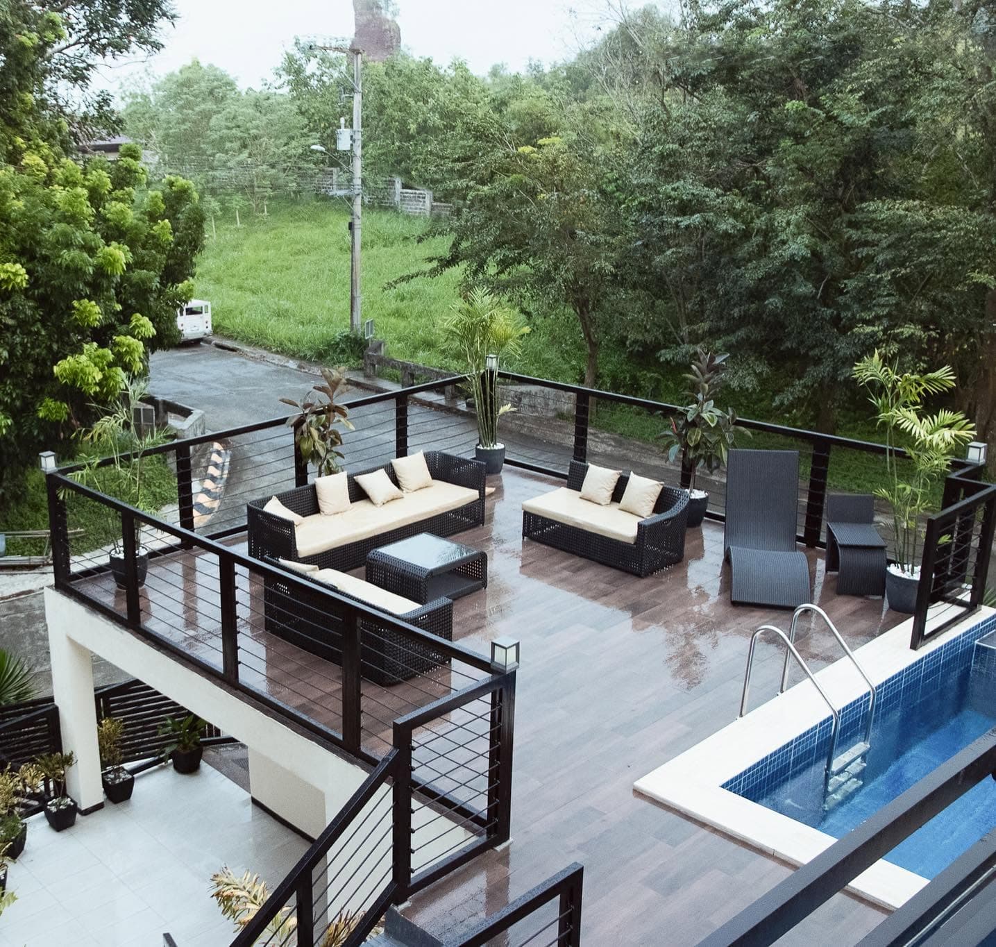 Open sun deck with lounge sofas overlooking the hillside canopy
